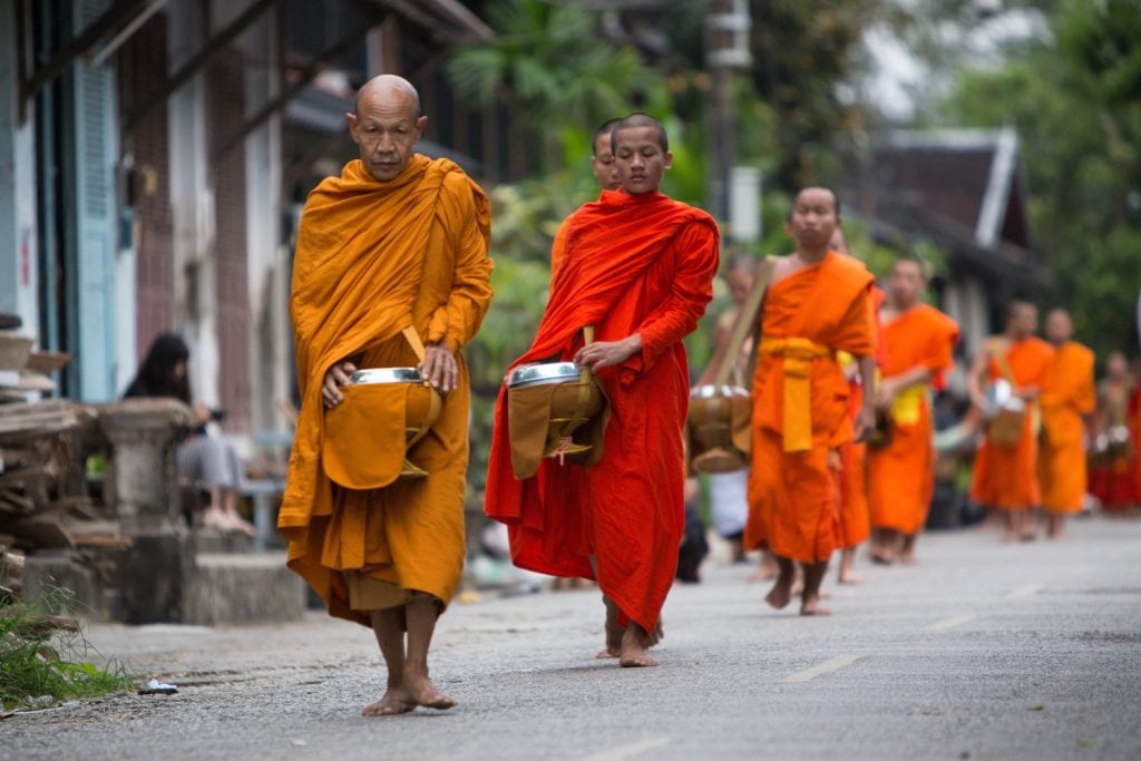 The tak bat, morning alms of Buddhist monks' morning collection of food in Luang Prabang
