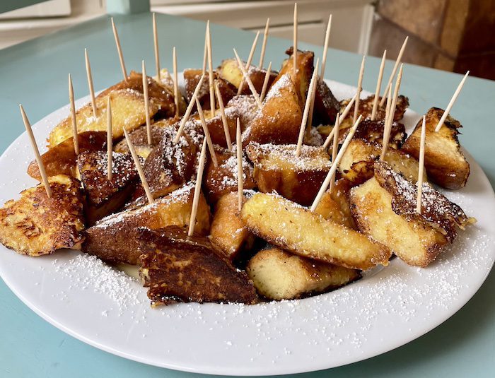 Gluten-free brioche French toast bites with toothpicks for fork-free eating